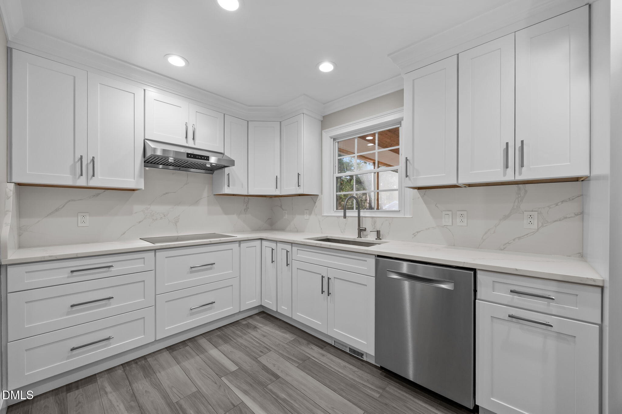 3009 Kenan Road Durham, NC 27704 - Photo 14 of 24 a kitchen with white cabinets appliances a sink and dishwasher with wooden floor
