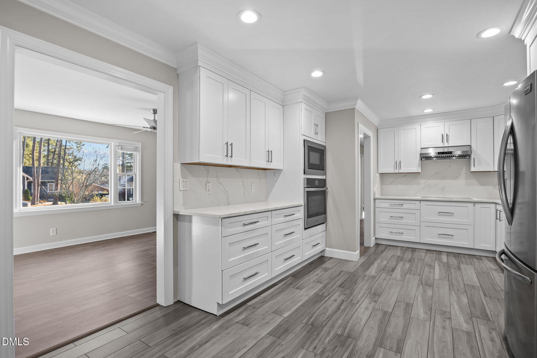 3009 Kenan Road Durham, NC 27704 - Photo 15 of 24 a kitchen with stainless steel appliances a refrigerator and wooden floor