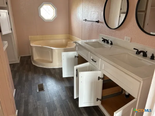 a bathroom with a sink and a mirror