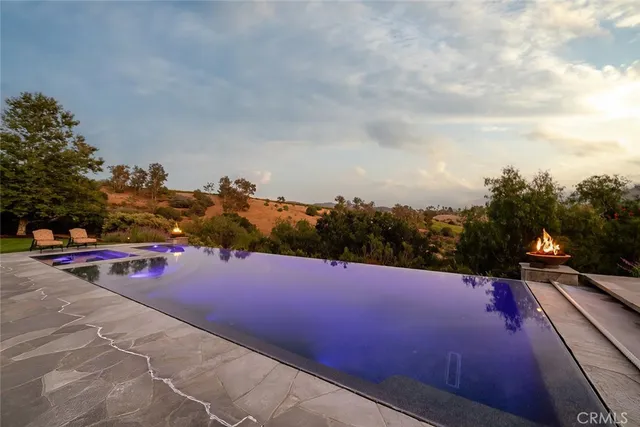 a view of a patio with couches table and chairs and potted plants