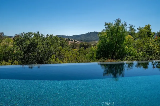 a view of a chair and table in wooden floor
