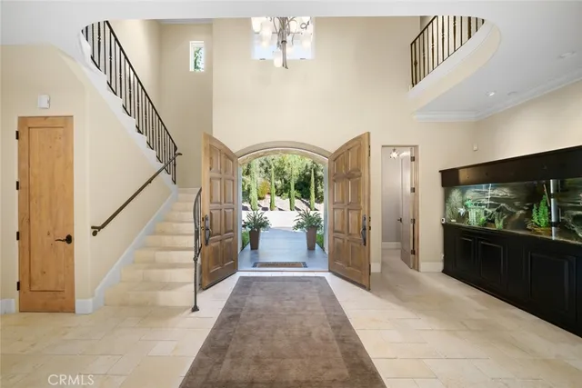a bedroom with furniture and a large window