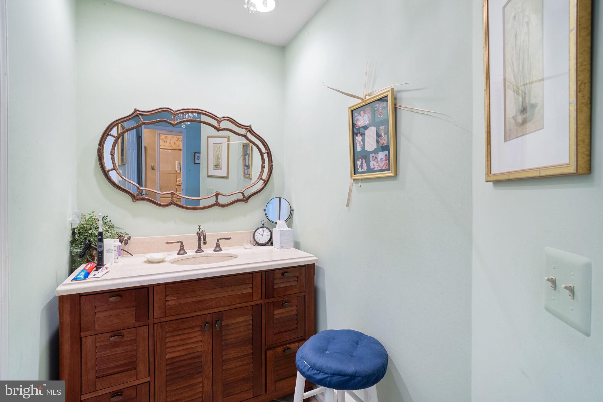 87 Ash Road Manahawkin, NJ 08050 - Photo 23 of 27 a bathroom with a sink and a mirror
