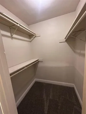 a view of walk in closet with clothes