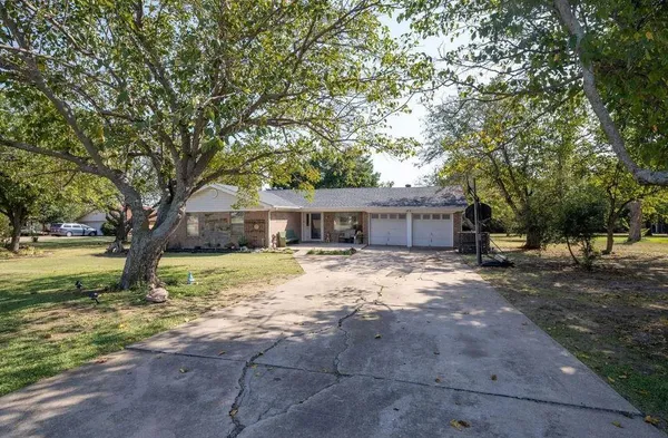 a view of a house with a yard covered in snow