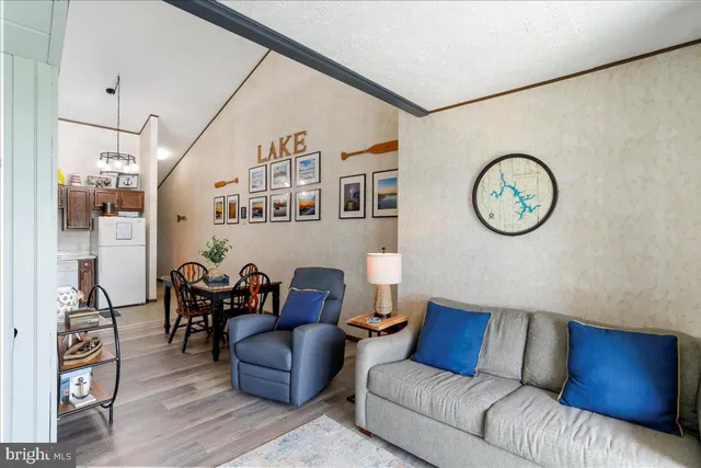 a living room with furniture a clock on wall and a table
