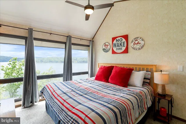 a bedroom with a bed and a large window