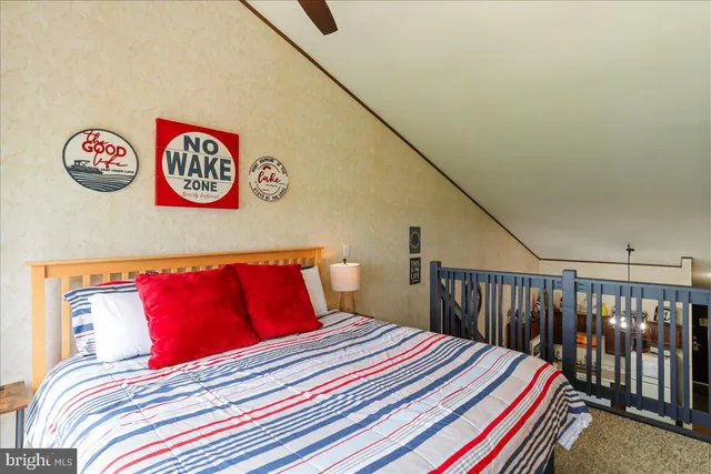 a bedroom with a bed and a book shelf