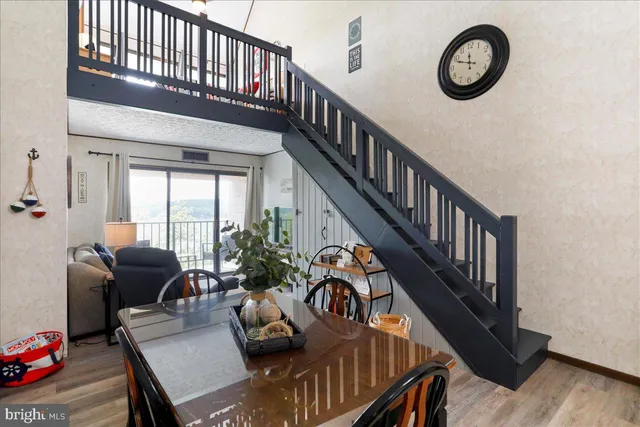 a view of entryway livingroom and hall with wooden floor