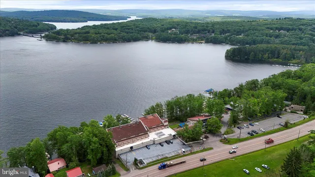 an aerial view of a house with garden space and lake view