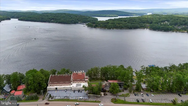 an aerial view of a house with a yard and lake view