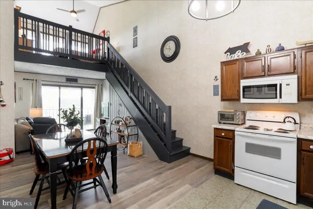 a view of kitchen with furniture stove and wooden floor