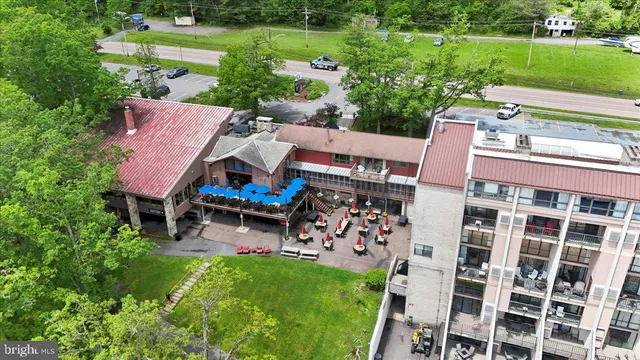 an aerial view of a house with a yard table and chairs