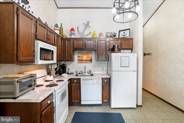 a kitchen that has a sink and a stove top oven