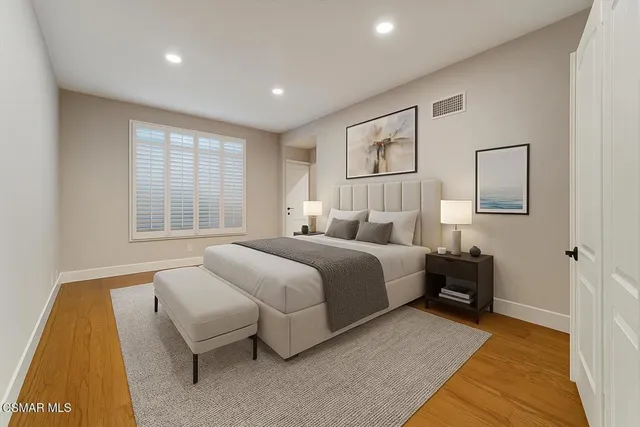 a bedroom with a bed and a couch