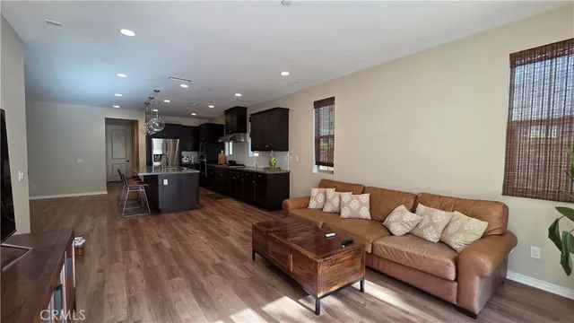 a living room with furniture and kitchen view