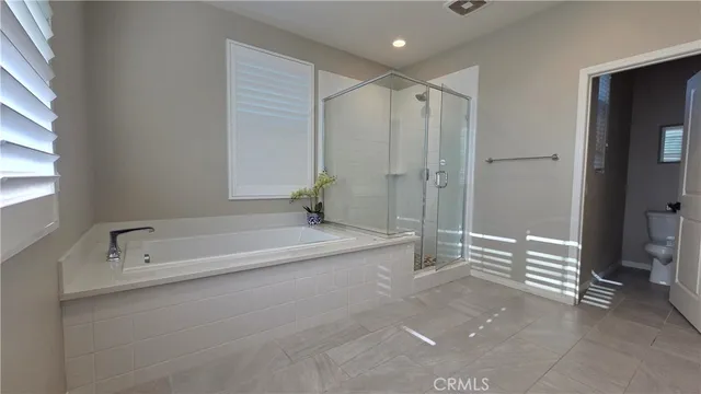a spacious bathroom with a bathtub and a shower