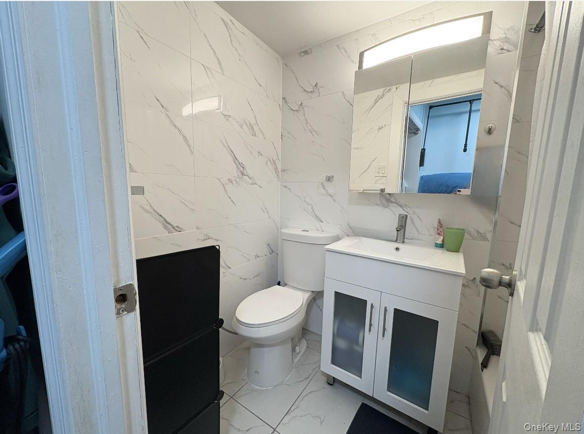 61-15 97th Street, Unit 15P Queens, NY 11374 - Photo 4 of 18 a bathroom with a sink and toilet