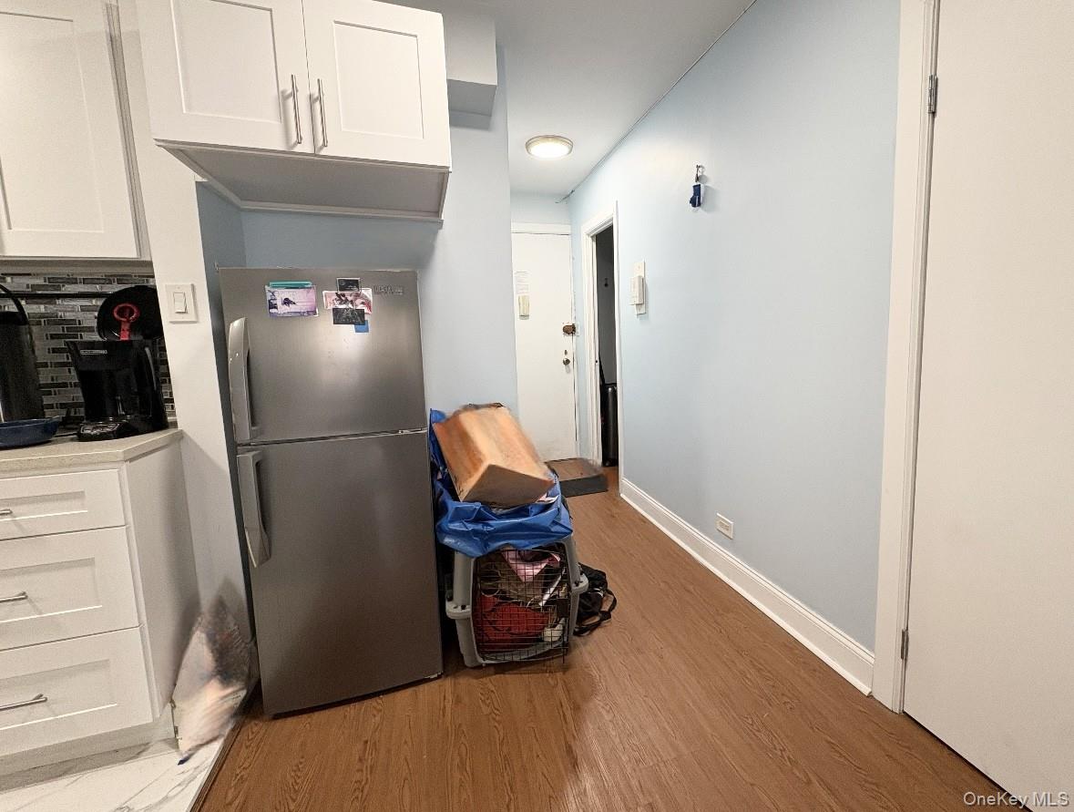 61-15 97th Street, Unit 15P Queens, NY 11374 - Photo 7 of 18 a room with wooden floor and furniture