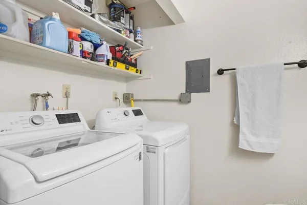 a bathroom with a toilet a sink a mirror and a shower