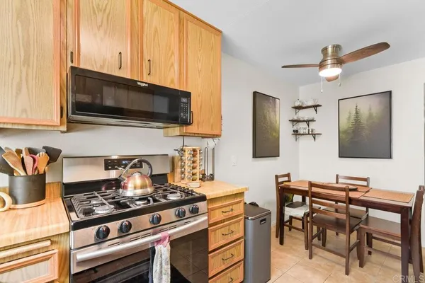 a view of kitchen with furniture and a refrigerator