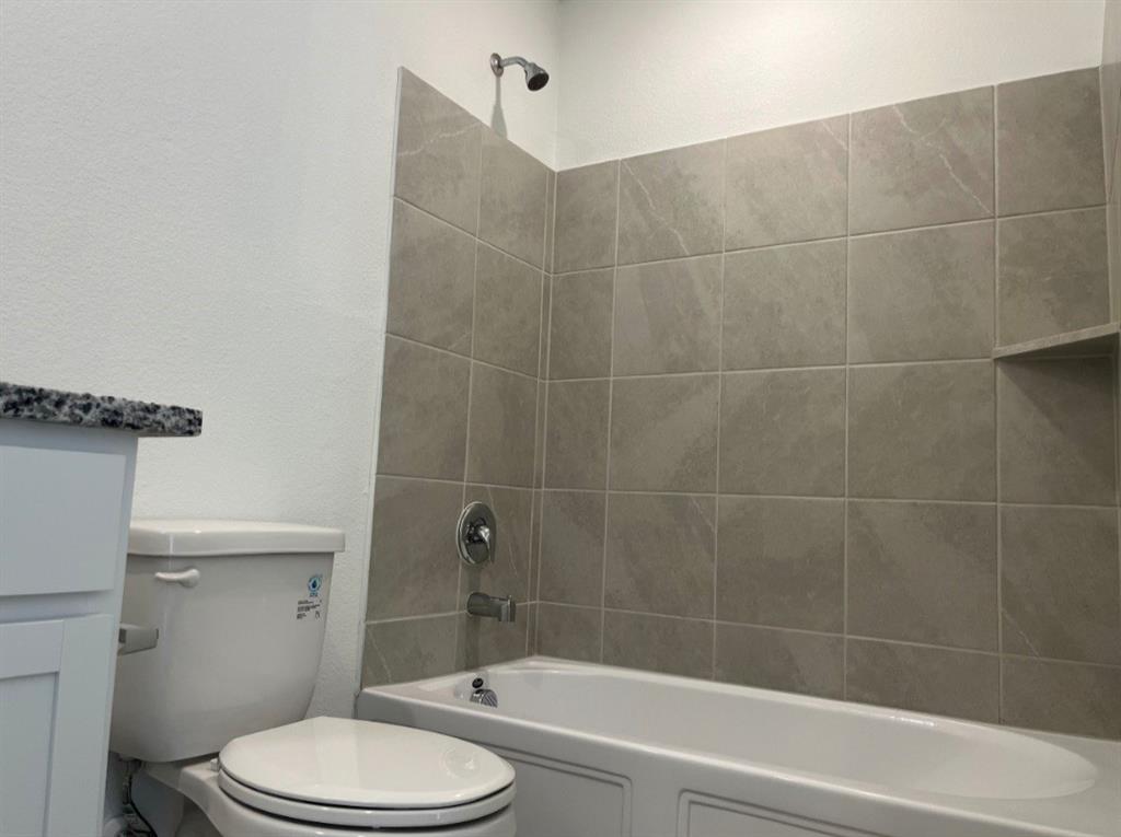 252 Jethro Lane Princeton, TX 75407 - Photo 11 of 20 a bathroom with a toilet and shower