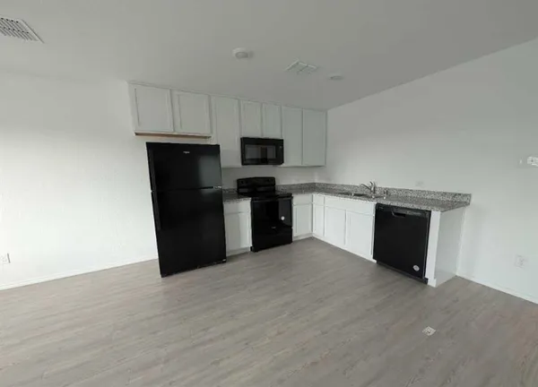 a kitchen with a refrigerator stove and microwave