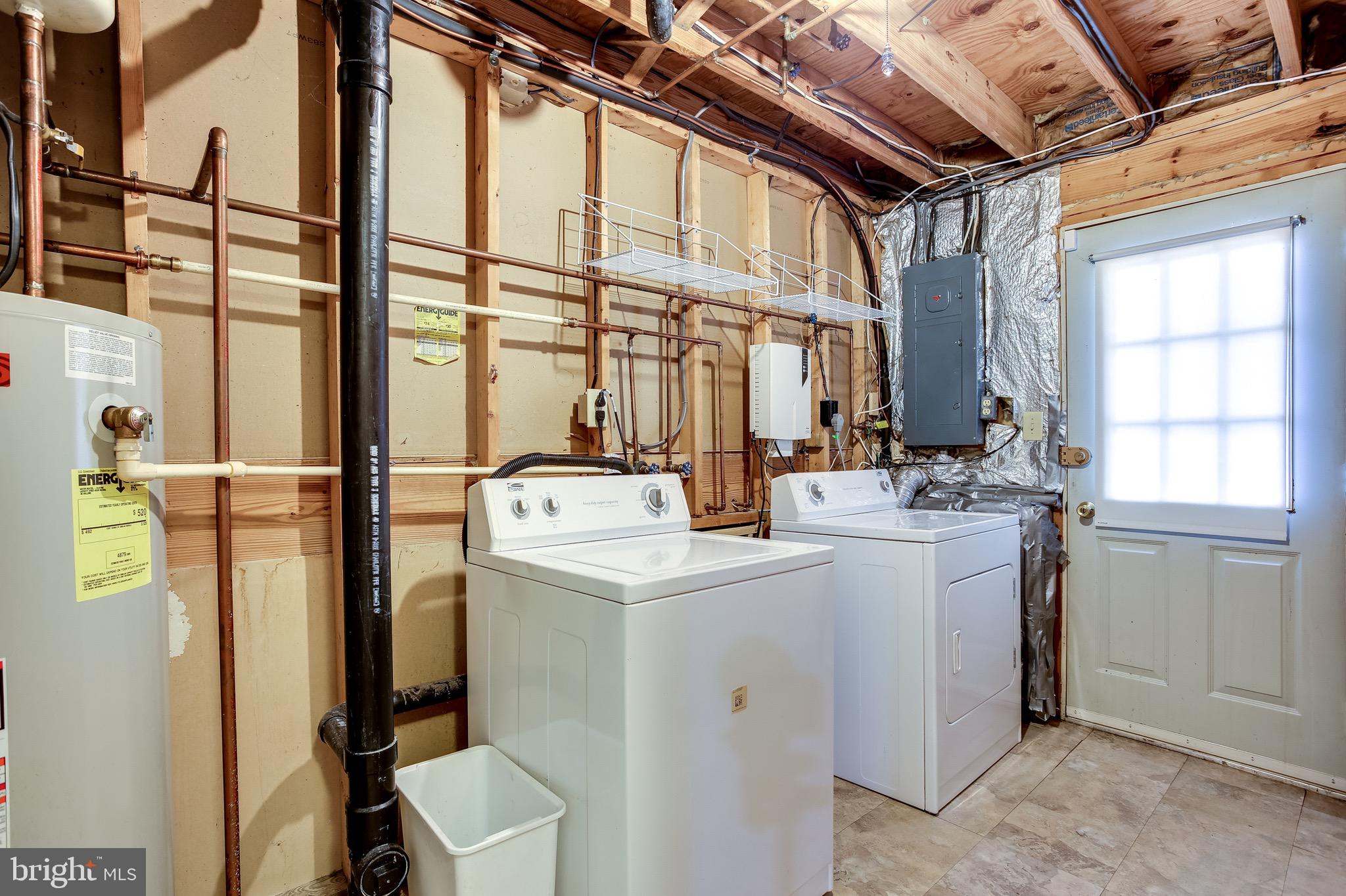 7719 Baggins Road Hanover, MD 21076 - Photo 24 of 30 Lower Level Laundry Area with Crawl Space Storage