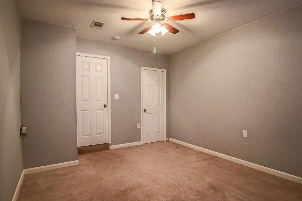 3011 37th Street Lubbock, TX 79413 - Photo 10 of 11 an empty room with closet and a chandelier fan