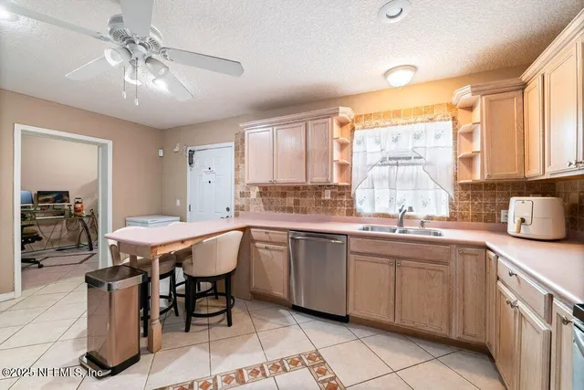 a spacious kitchen with a sink and large windows