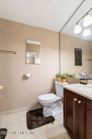 a bathroom with a sink a toilet and mirror