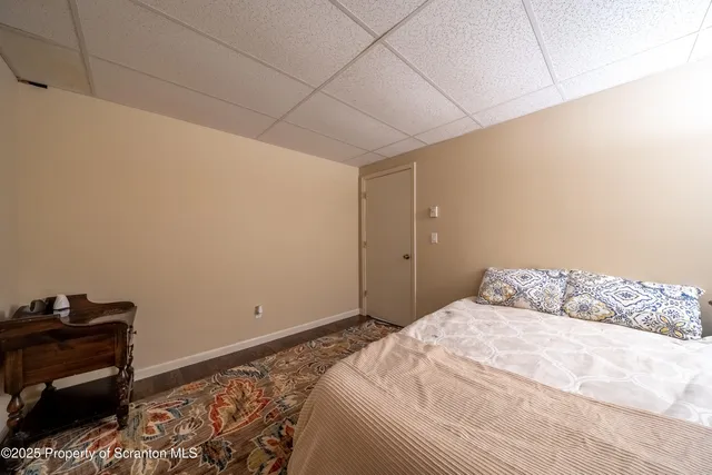 a bedroom with a bed and a piano