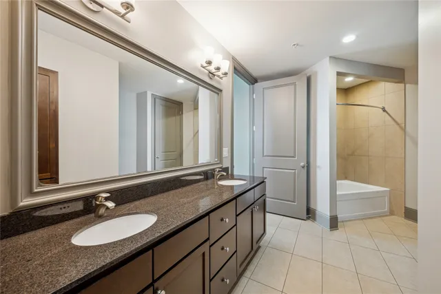 a spacious bathroom with a granite countertop sink mirror and a