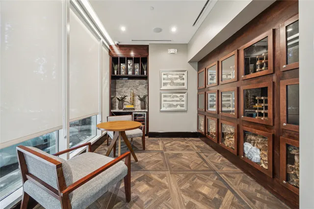 a kitchen with stainless steel appliances granite countertop a stove a sink dishwasher a microwave oven and a dining table with wooden floor