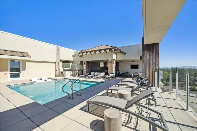 a view of a house with swimming pool and sitting area