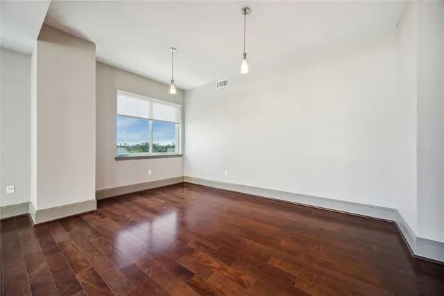 a view of a room with wooden floor and window