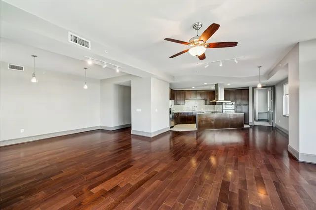a view of a living room and kitchen with furniture wooden floor