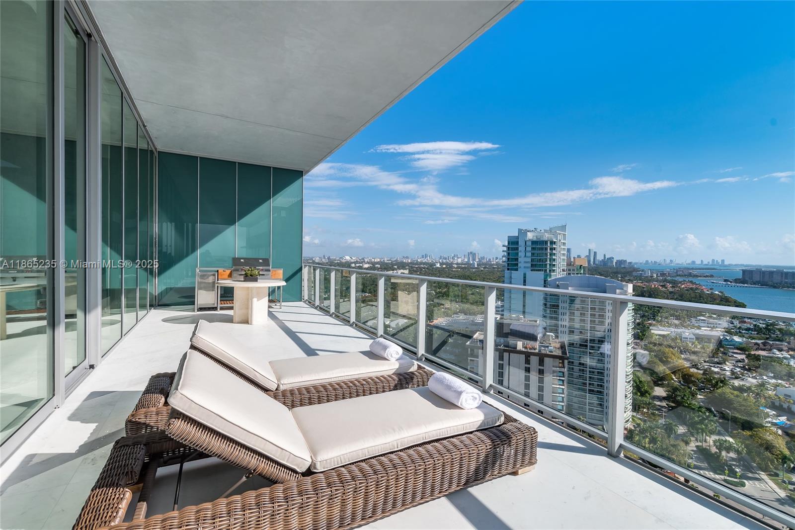 2669 South Bayshore Drive, Unit PH1N Coconut Grove, FL 33133 - Photo 12 of 39 a view of a balcony with floor to ceiling window and wooden floor