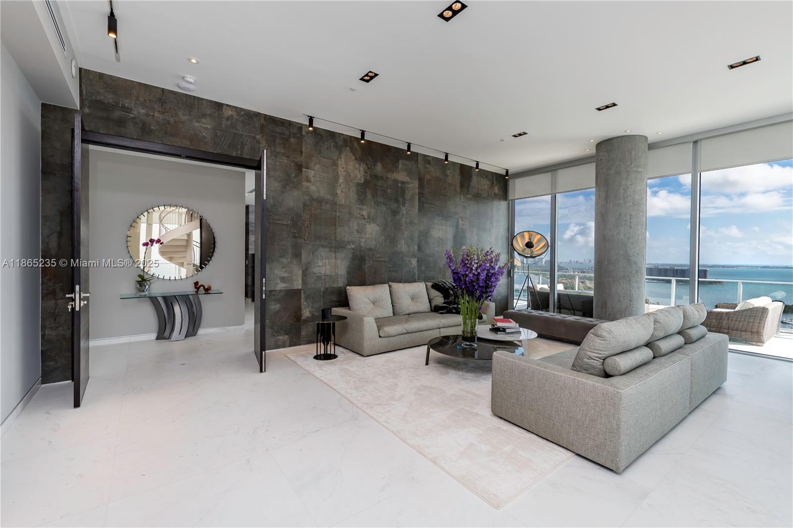 2669 South Bayshore Drive, Unit PH1N Coconut Grove, FL 33133 - Photo 13 of 39 a living room with furniture and a large window