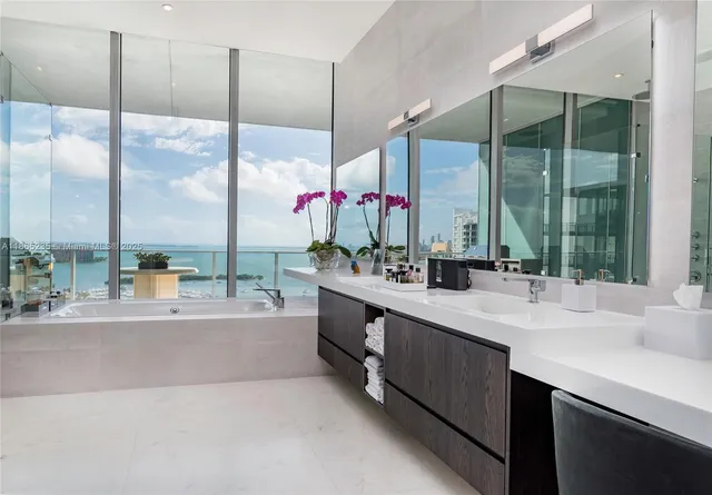 a reception area with glass top table and sofas