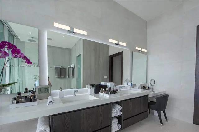 a spacious bathroom with a large tub and chandelier