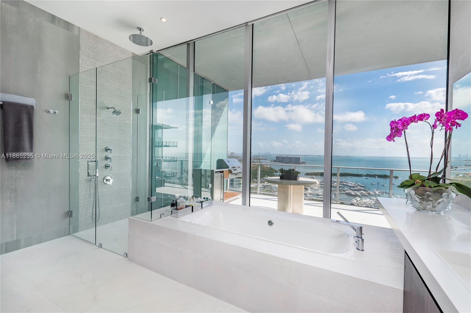 2669 South Bayshore Drive, Unit PH1N Coconut Grove, FL 33133 - Photo 19 of 39 a spacious bathroom with a large tub and chandelier