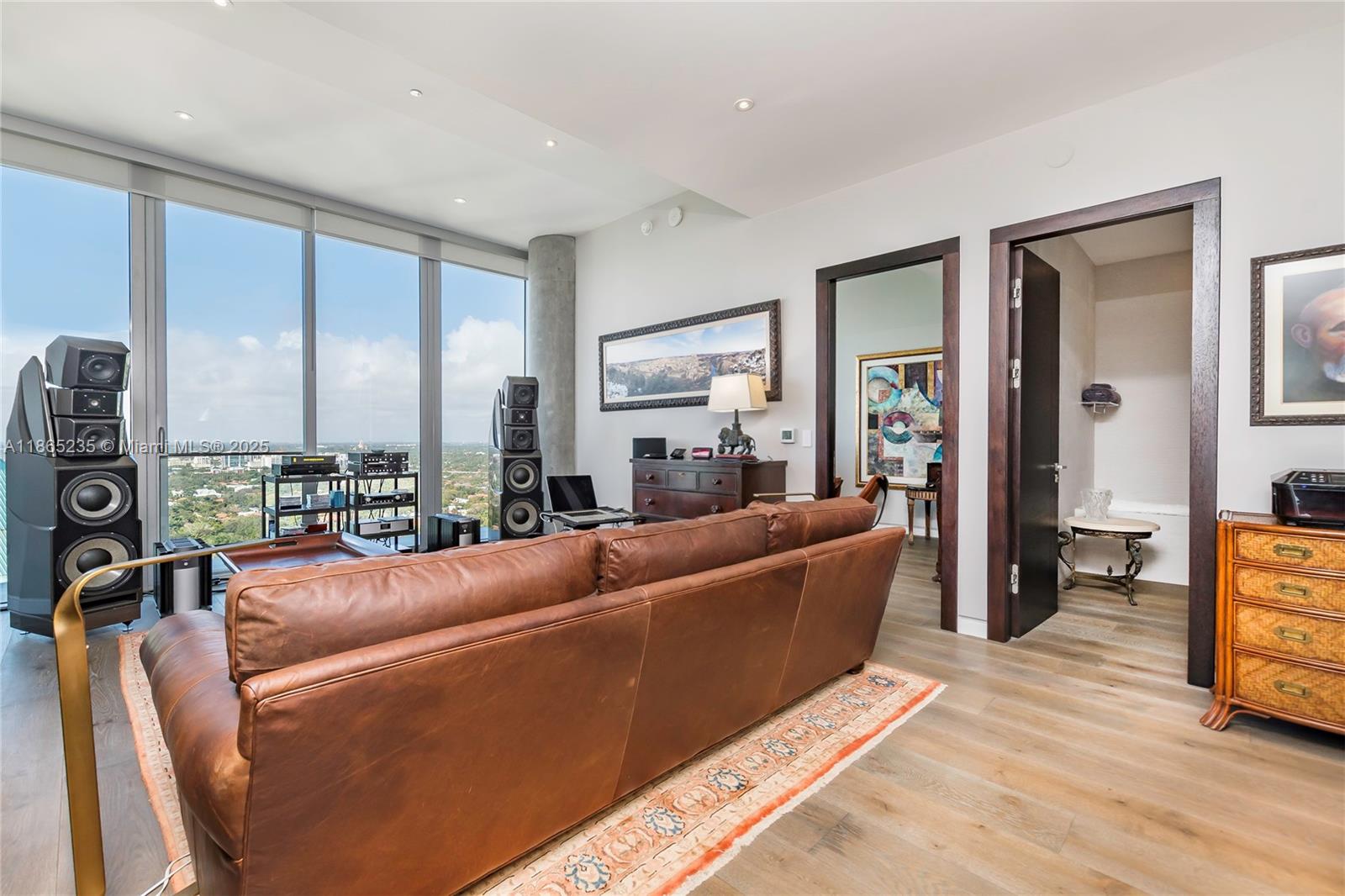 2669 South Bayshore Drive, Unit PH1N Coconut Grove, FL 33133 - Photo 26 of 39 a living room with furniture window and a wooden floor