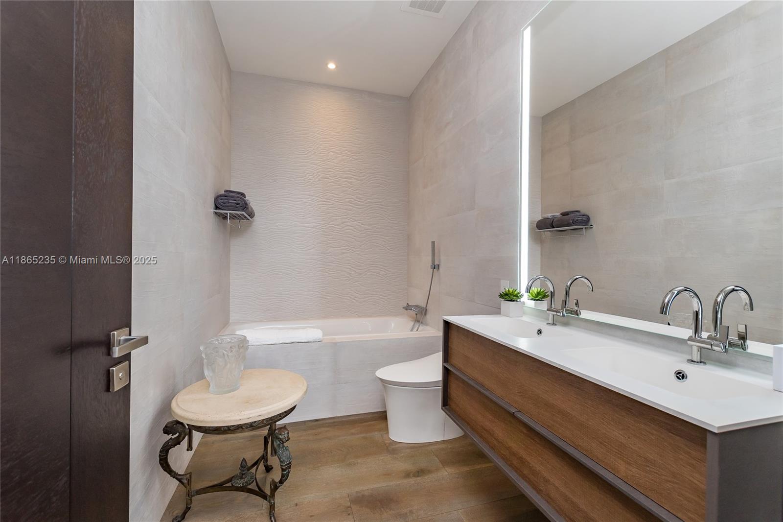 2669 South Bayshore Drive, Unit PH1N Coconut Grove, FL 33133 - Photo 27 of 39 a bathroom with a toilet sink and mirror