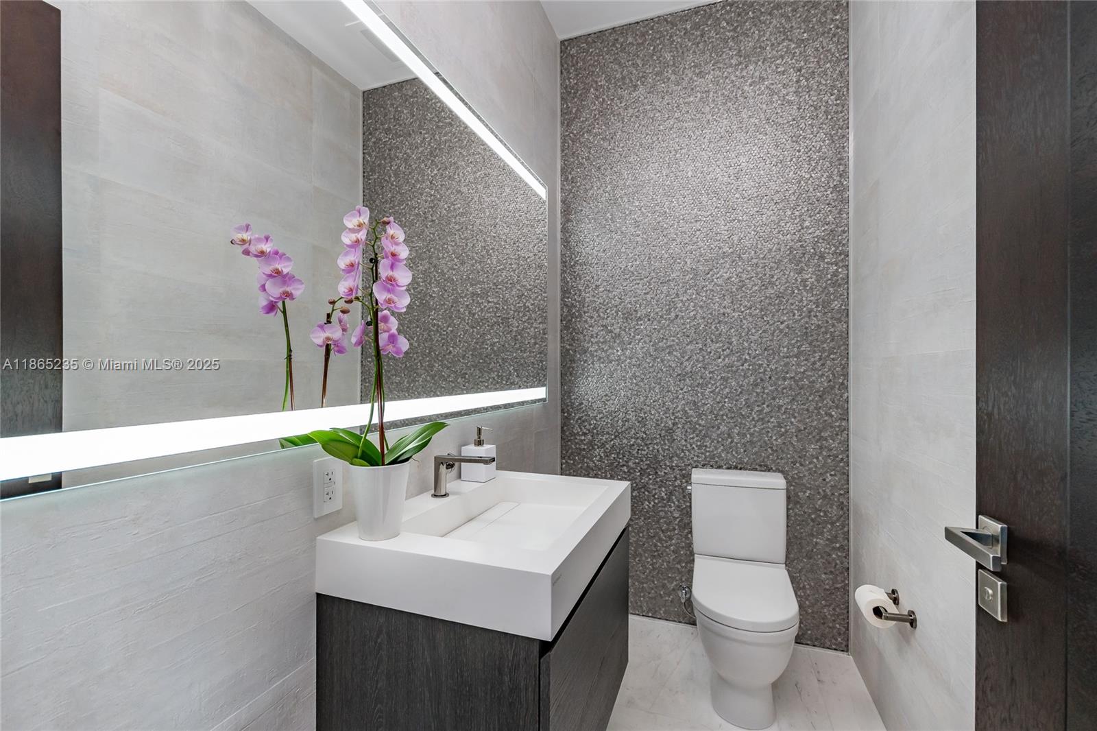 2669 South Bayshore Drive, Unit PH1N Coconut Grove, FL 33133 - Photo 36 of 39 a bathroom with a sink toilet and a mirror