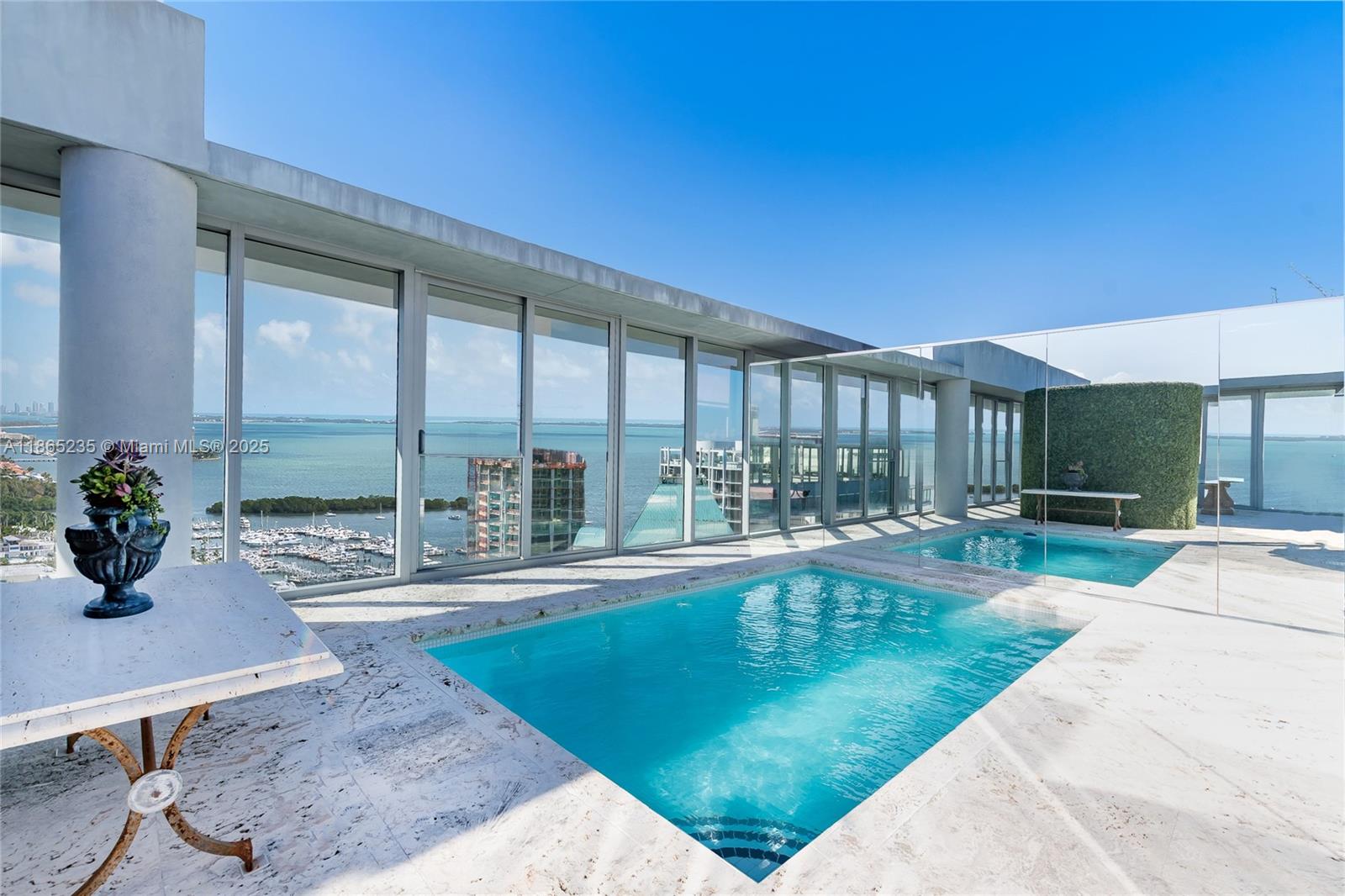 2669 South Bayshore Drive, Unit PH1N Coconut Grove, FL 33133 - Photo 8 of 39 a view of a patio with a table and chairs