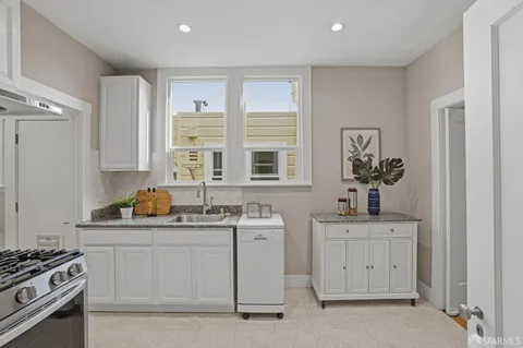 a kitchen with a stove a sink and a refrigerator