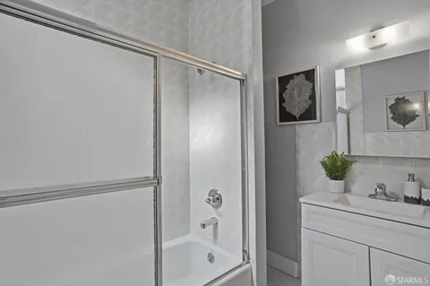 a bathroom with a shower sink and mirror