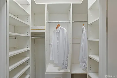 a view of walk in closet with empty racks