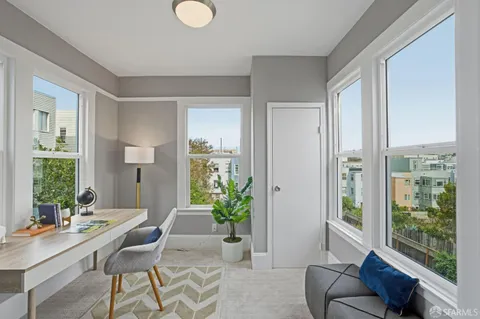 a living room with furniture and a potted plant
